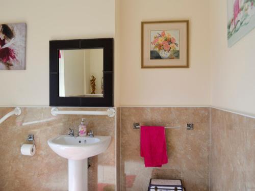 a bathroom with a sink and a mirror at Kinvara in Stranraer