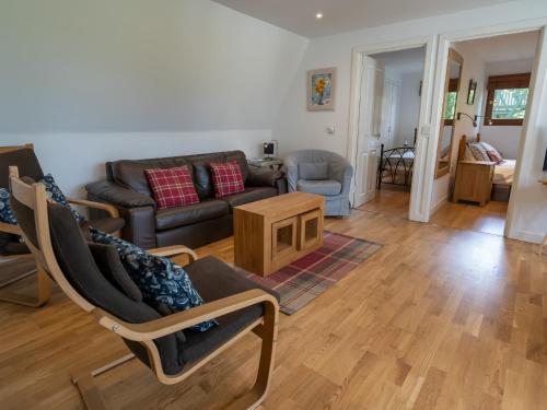 a living room with a couch and a table at Ledi - Cottage in Linlithgow