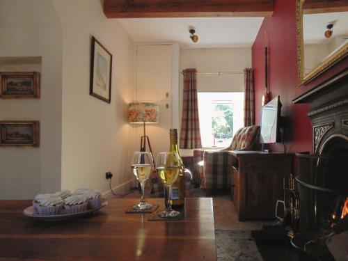 a living room with a table with two glasses of wine at Newburgh C Listed Townhouse in Newburgh