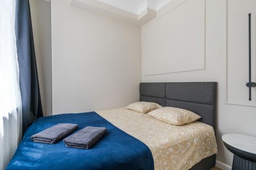 a bedroom with a bed with two pillows on it at Holy Spirit Street Apartments in Gdańsk
