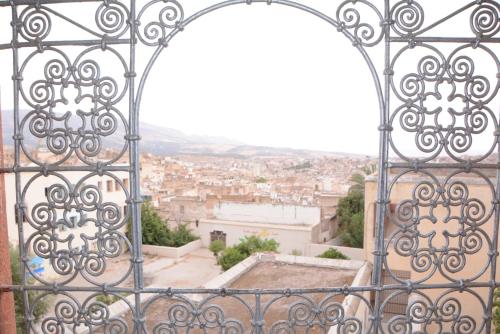 an iron gate with a view of a city at Dar El Karam Fez in Fès