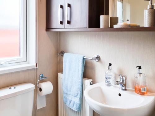 a bathroom with a sink and a mirror at Glen Clova in Forfar