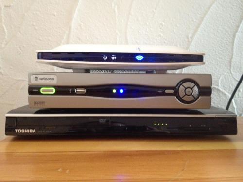 three laptops stacked on top of each other on a table at Chesa Panorama in Celerina