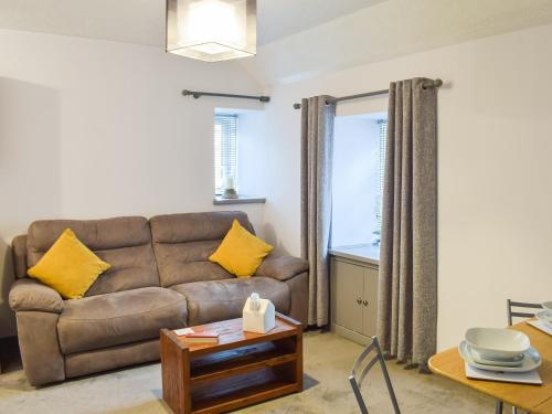 a living room with a couch and a table at The Cottage in Girvan