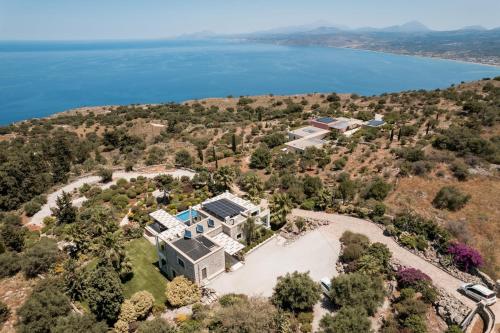 an aerial view of a large house on a hill next to the water at BlueSkyline Owner's Listing, By Hellocrete in Chania Town