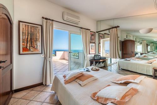 a bedroom with two beds and a view of the ocean at Holiday home in Cala Gonone Nuoro Provinz 40363 in Cala Gonone