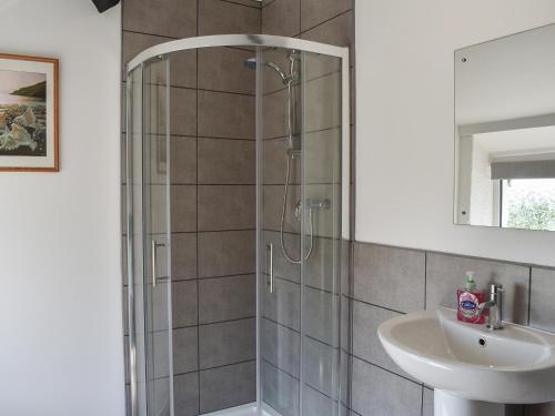 a bathroom with a shower and a sink at Uk40277 - Llys Elen Two in Brynsiencyn