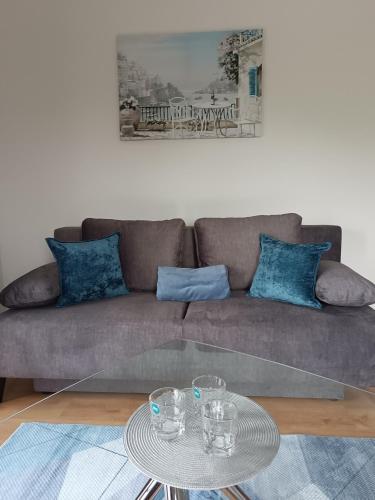 a living room with a couch and a glass table at Apartament Kwiatowa in Puławy