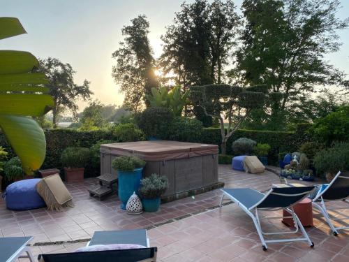 a patio with chairs and a hot tub at La Casa di SASI in Sabaudia