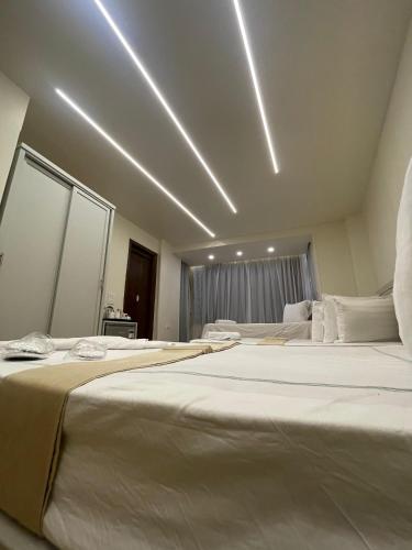 two large beds in a hotel room with lights at Ambiance Downtown Cairo Hotel in Cairo
