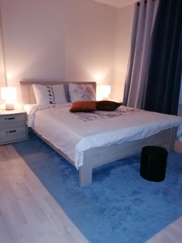 a bedroom with a bed with white sheets and pillows at Une chambre chez l'habitant près de l'aéroport de Charleroi in Charleroi