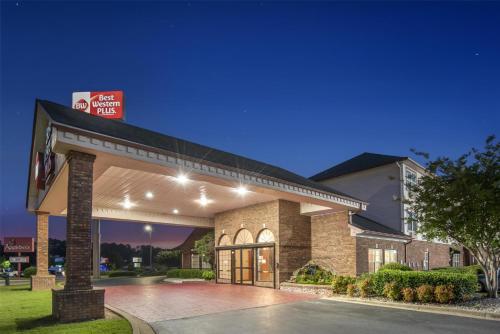 a hotel with a sign on the front of a building at Best Western Plus Bessemer in Bessemer
