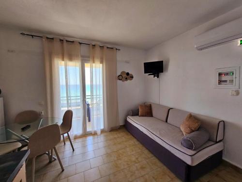 a living room with a couch and a table at Corfu Glyfada Menigos Resort 25 in Glyfada