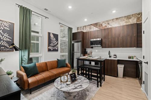 a living room with a couch and a kitchen at Walk to Everything in Old City- ADA compliant unit in Philadelphia