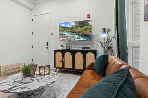 a living room with a couch and a table at Walk to Everything in Old City- ADA compliant unit in Philadelphia