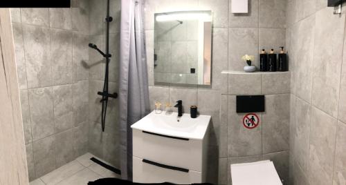 a bathroom with a white sink and a shower at Villa Leah in Gerakini