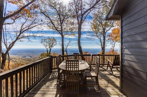 a table and chairs on a deck with a view at Canoe Believe It - Enjoy mountain views cook out on the Weber grill relax in Jasper