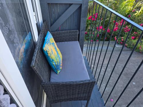 a chair with two pillows sitting on a balcony at Martello Bay Hotel in Clacton-on-Sea