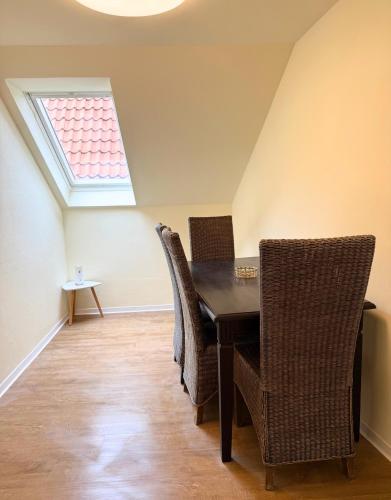 a dining room with a table and chairs at OK Apartment Petershagen in Petershagen