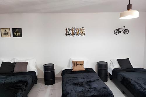a living room with two beds and a couch at Casa Fundidora in Monterrey
