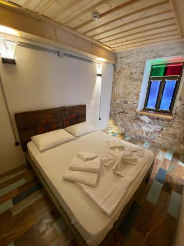 a large bed in a room with a window at Latibule Adahan Guest House in Ayvalık
