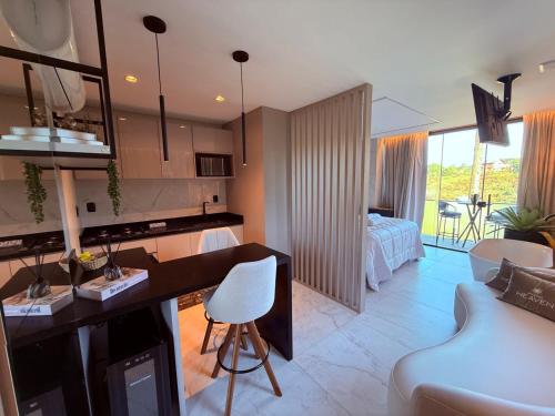 a kitchen and living room with a desk and a couch at Studios Heaven in Gramado