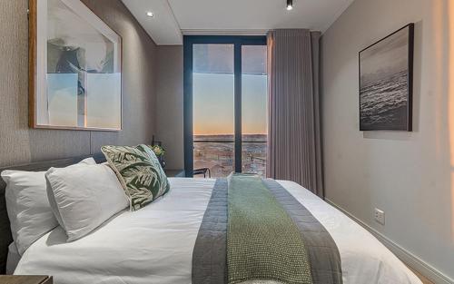 a bedroom with a large bed and a window at 5 Star Elegant Apartments, Ellipse, Waterfall City, Midrand, Johannesburg in Midrand