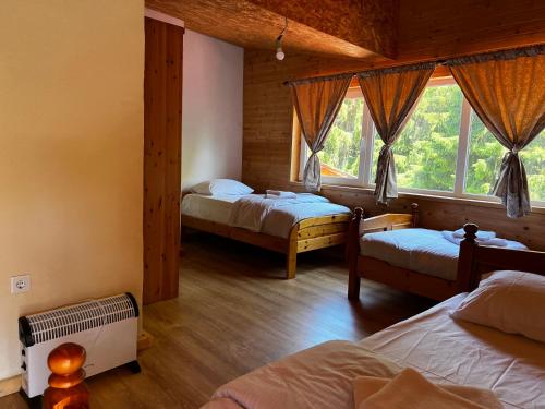 a bedroom with two beds and a window at Resort Komovi in Kravlja