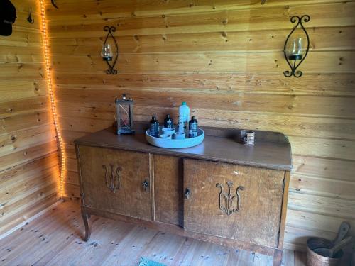a bathroom with a sink in a wooden wall at Mistel in Filipstad