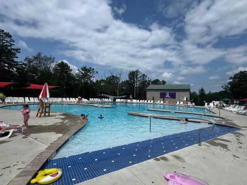 a large swimming pool with people in the water at The Flying Dutchman Cottage in amenities filled Masthope community Ski Big Bear in Lackawaxen