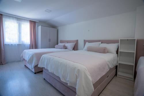 a bedroom with two beds and a window at Vila Sanela in Sarajevo