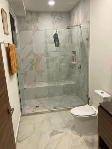 a bathroom with a shower and a toilet at Suite Privada frente a Vidanta Queen in Nuevo Vallarta