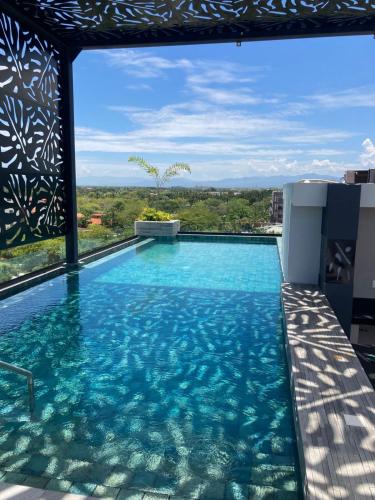 a swimming pool with a view of the water at Suite Privada frente a Vidanta Queen in Nuevo Vallarta