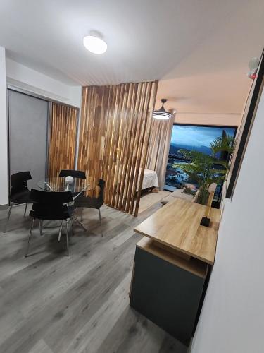 a living room with a table and a dining room at Escalante Loft in San José