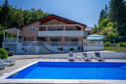 a villa with a swimming pool and a house at Vila Sanela in Sarajevo