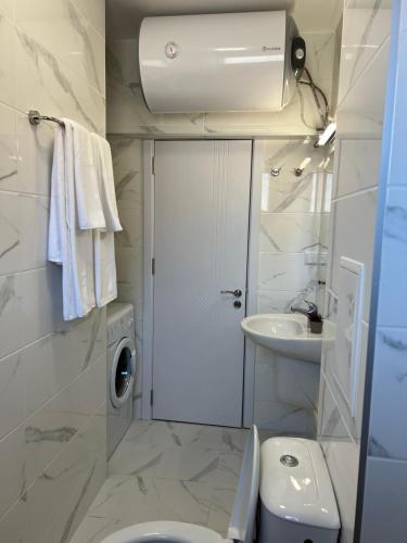 a small bathroom with a toilet and a sink at Apartment D25 Pomorie in Pomorie