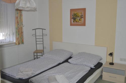 a bedroom with a bed and a desk with a ladder at Ferienhaus Erika in Geringswalde