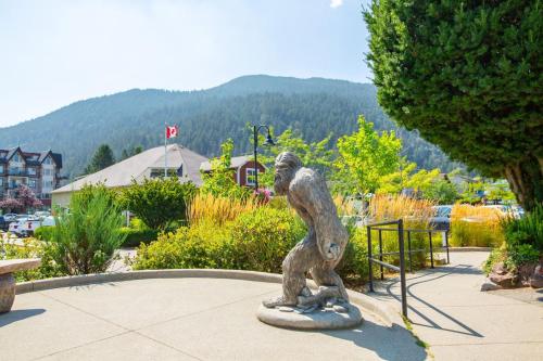 a statue of a monkey standing in a park at The Riverbend Modern Studio at Harrison Lake in Harrison Hot Springs