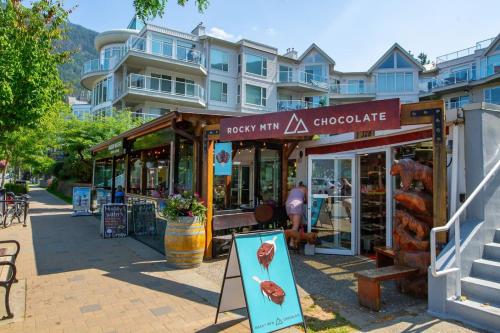 a store with a sign in front of a building at The Riverbend Modern Studio at Harrison Lake in Harrison Hot Springs