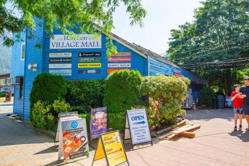 a building with signs on the side of it at The Riverbend Modern Studio at Harrison Lake in Harrison Hot Springs