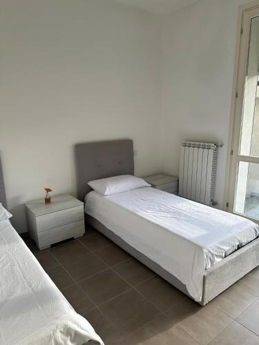 a bedroom with two beds and a window at La Siesta in Seregno