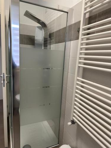 a glass shower in a bathroom with a toilet at La Siesta in Seregno
