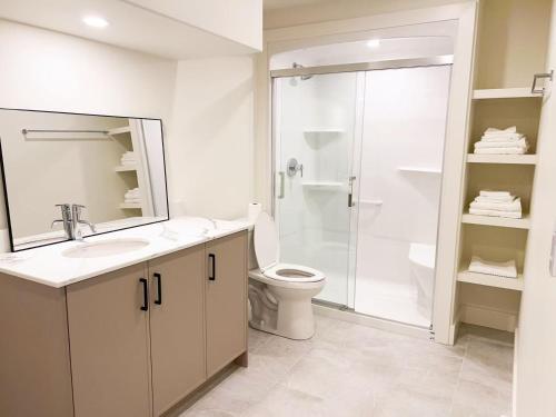 a bathroom with a toilet and a sink and a shower at Morning Dew105 in Hammonds Plains