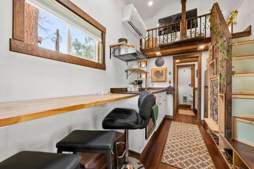 a tiny house with a bar and stools at The Fern Hollow Retreat in Woodland Park