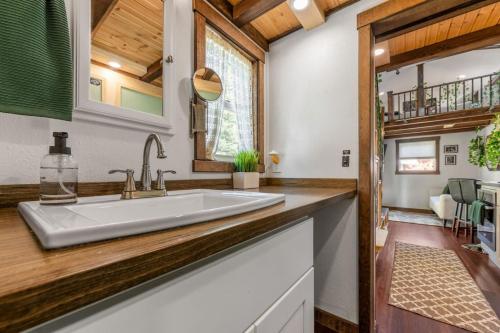 a kitchen with a large white sink and wooden counters at The Fern Hollow Retreat in Woodland Park