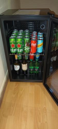 a refrigerator filled with lots of drinks and soda at Holiday Home Forest Peace, Lavrovec in Hlevni Vrh