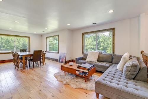 a living room with a couch and a table at 3 Mi to Colgate Lake Mtn-View Home, Deck and Grill! in East Jewett