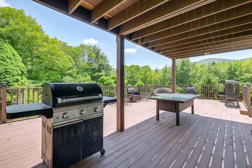 a patio with a grill and a table on a deck at 3 Mi to Colgate Lake Mtn-View Home, Deck and Grill! in East Jewett