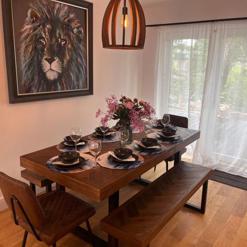 a dining room table with a lion painting on the wall at The Fishermans Rest in Castle Douglas