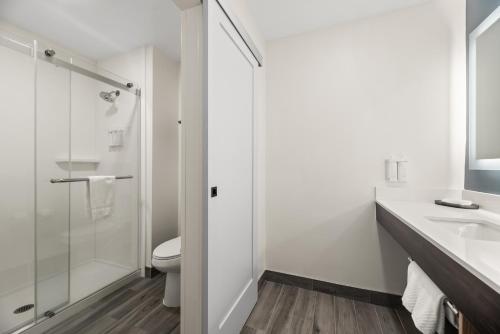 a bathroom with a shower and a toilet and a sink at The Ellsworth Hotel, an Ascend Collection Hotel in Williams
